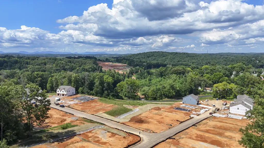 Aerial view of build-ready lots and new homes in a Clouds Rest community, with East Tennessee mountains beyond